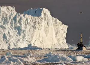 A fishing boat near the icebergs of Greenland.